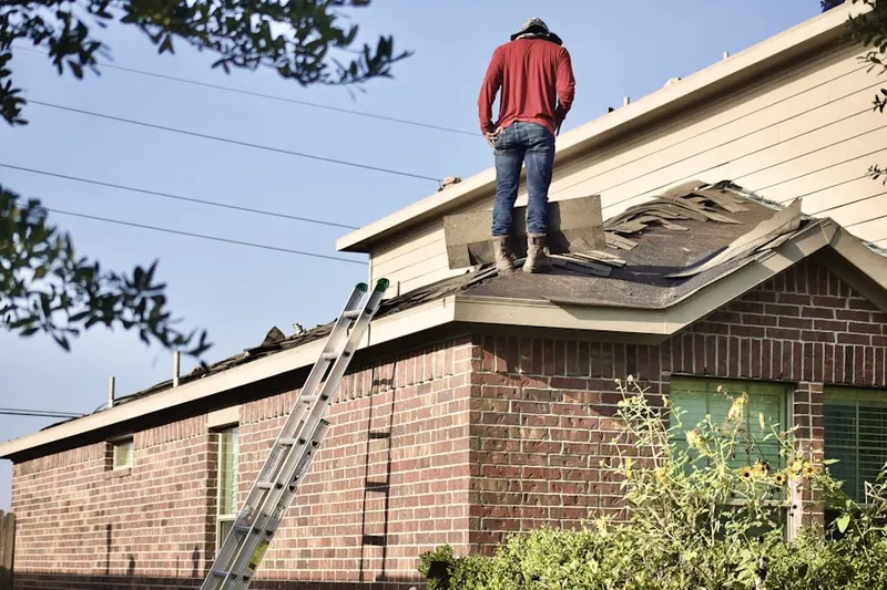 Professional roofer working on a residential roof in Madison Park